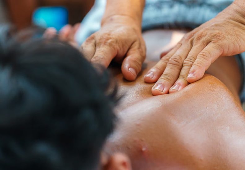 Close-up of hands performing a therapeutic back massage, promoting relaxation and wellness.